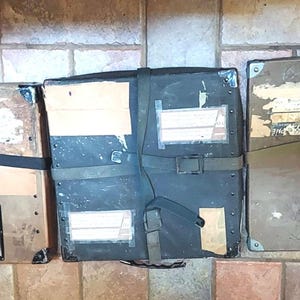 Three 16 mm film reel, fiberboard, shipping containers with canvas straps and metal edging