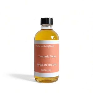 May include: A clear glass bottle with a black cap, filled with a golden-yellow liquid. The bottle has a salmon-colored label with the text "Turmeric Toner" and "MADE IN THE USA". The brand name "NaturaleLivingShop" is also visible.