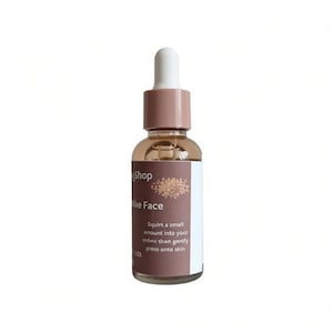 May include: A clear glass bottle with a dropper, filled with a light brown liquid. The bottle has a white and brown label with the text "Shop", "Hike Face", and instructions. The dropper top is white and brown.