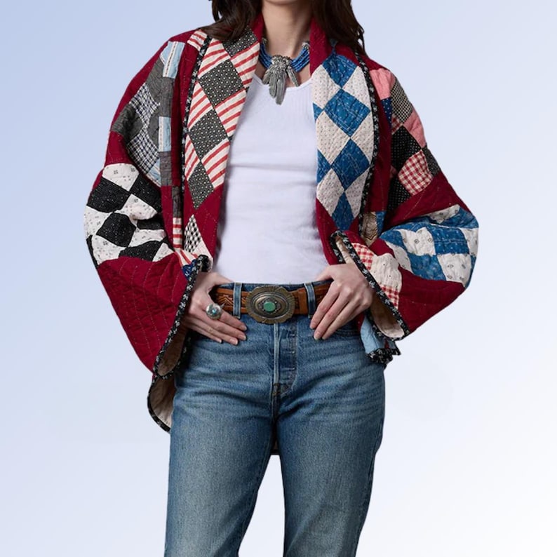 May include: A quilted jacket featuring a patchwork design of red, blue, white, and black diamond and square patterns. The jacket has wide sleeves, a dark trim, and is worn over a white tank top with blue jeans and a brown leather belt.