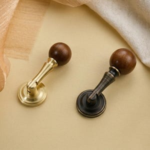 May include: A white ceramic mug with a black handle and the text "But First, Coffee" in a black, bold font. The mug is sitting on a white surface. The mug is approximately 4 inches tall.