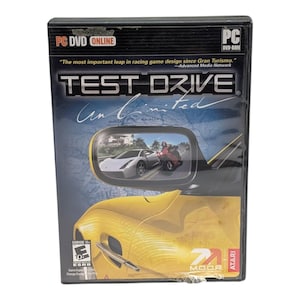 May include: A Test Drive Unlimited PC DVD-ROM game case featuring a yellow sports car on the cover. The artwork displays a side mirror reflecting a silver car and a red motorcycle on a road. The text includes the title, PC DVD Online, and ESRB E10+.