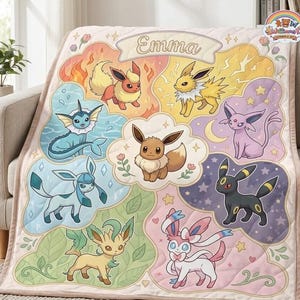 May include: A quilted throw blanket featuring a central Eevee surrounded by its evolutions including Flareon, Jolteon, Vaporeon, Espeon, Umbreon, Glaceon, Leafeon, and Sylveon. The top banner displays the name Emma in a decorative script font.
