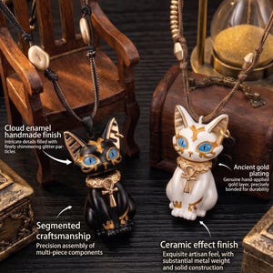 May include: Two cat pendant necklaces. One is black with gold accents and blue eyes, the other is white with gold accents and blue eyes. Both have intricate details and are suspended from a cord.
