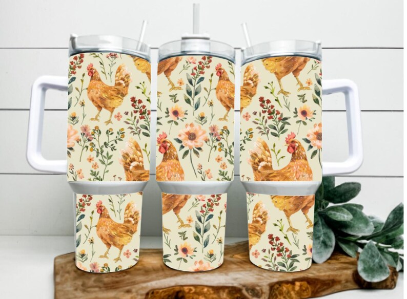 May include: Three stainless steel travel mugs with white handles and lids. The mugs feature a repeating pattern of watercolor chickens, flowers, and foliage on a cream background. Each mug has a straw.