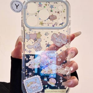 May include: Clear phone case with a light blue border, featuring cartoon characters, stars, and the text "yummy dessert". The case has a glittery background and the text "I wish you happy every day".
