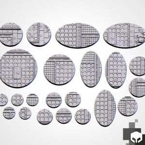 May include: A collection of light gray miniature bases in various circular and oval shapes, featuring textured surfaces with geometric patterns including grids, hexagons, and decorative border details for tabletop gaming figures.