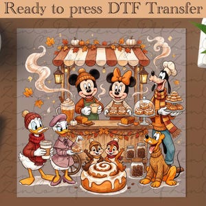May include: Ready to press DTF Transfer featuring a fall-themed bakery scene with cartoon characters. Mickey, Minnie, Goofy, Donald, Daisy, Pluto, and Chip and Dale are shown with cinnamon rolls, coffee, and autumn leaves in shades of brown and orange.