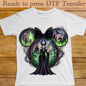 May include: A white ceramic mug with a black handle and the text "But First, Coffee" in a bold, black font. The mug is set against a neutral background, highlighting its simple design.