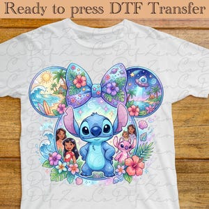May include: White t-shirt featuring a colorful graphic of Stitch, surrounded by tropical scenes and characters. The design includes a large bow, flowers, and the text "Ready to press DTF Transfer" at the top.