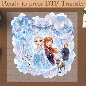 May include: A DTF transfer featuring Elsa and Anna from Frozen, with Olaf, Kristoff, and Sven. The design includes a castle, mountains, and snowflakes, all within a blue and white color scheme. Text at the top reads "Ready to press DTF Transfer."