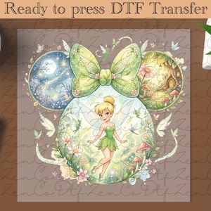 May include: A DTF (Direct to Film) transfer featuring a whimsical design. The image showcases a fairy with a green dress and wings, surrounded by flowers, mushrooms, and butterflies. The design includes a large green bow and two circular scenes with a moonlit sky and a fairy house. The text "Ready to press DTF Transfer" is at the top.