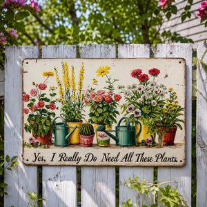 May include: A rectangular metal sign featuring a botanical illustration of various potted flowers, a small cactus, and two green watering cans. The text "Yes, I Really Do Need All These Plants" is printed in black script at the bottom of the sign.
