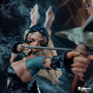 May include: A detailed figurine of a woman with long blonde hair, wearing a dark blue helmet with bunny ears and a teal top, aiming a bow and arrow. The figure has a determined expression. The background is a smoky blue.