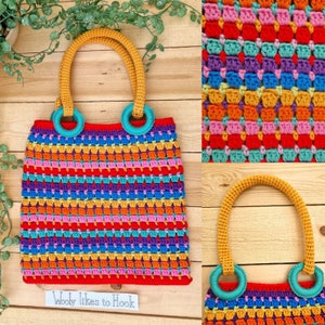 Puede incluir: Una bolsa de mano de crochet colorida con asas amarillas y anillos de color turquesa. La bolsa tiene un patrón a rayas de rojo, naranja, amarillo, verde, azul, morado y rosa. El texto "Wooly Likes to Hook" es visible en la parte inferior de la imagen.