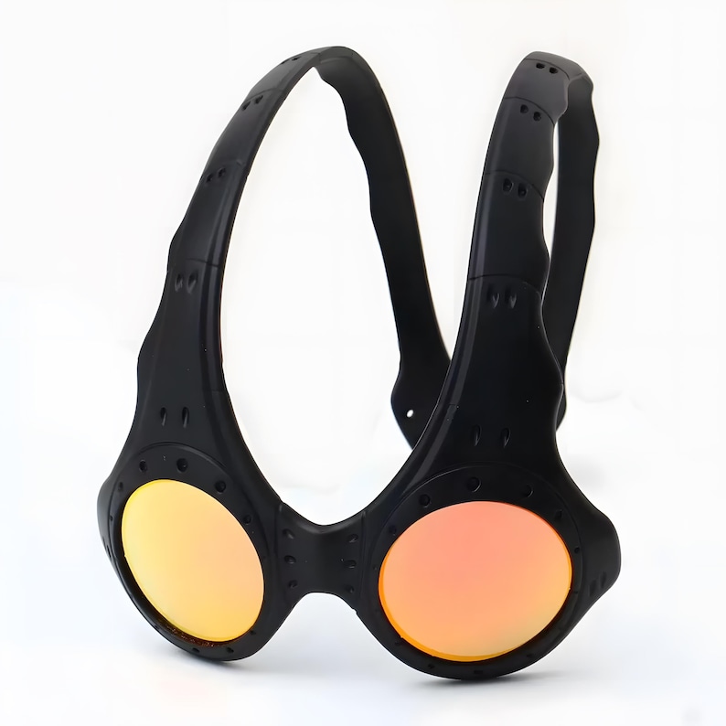 Authentic black Oakley Over-The-Top (OTT) sunglasses on a white background. This rare archive piece features a matte black sculptural frame with a unique over-the-head dual-arch design. The circular mirrored lenses show a vibrant gradient from gold to coral-orange. Detailed with industrial vents and rivets, this high-fashion collectible represents a pinnacle of Oakley’s futuristic bio-design, perfect for techwear, gorpcore, and avant-garde enthusiasts.
