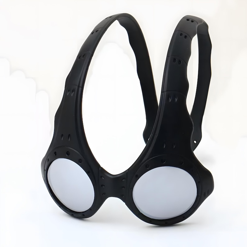 Authentic black Oakley Over-The-Top (OTT) sunglasses on a white background. This rare archive piece features a matte black sculptural frame with a unique over-the-head dual-arch design. The circular mirrored lenses show a vibrant gradient from gold to coral-orange. Detailed with industrial vents and rivets, this high-fashion collectible represents a pinnacle of Oakley’s futuristic bio-design, perfect for techwear, gorpcore, and avant-garde enthusiasts.