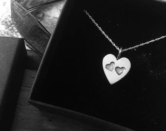 Silver heart pendant with two stamped hearts on an 18" silver chain