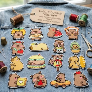May include: A collection of fifteen embroidered capybara patches arranged on a denim jacket. The patches feature various capybaras with food items like watermelon, bread, and donuts. A tan tag reads CURATED CAPYBARA COLLECTION HAND-FINISHED EMBROIDERY PATCHES OVER 15 UNIQUE DESIGNS.