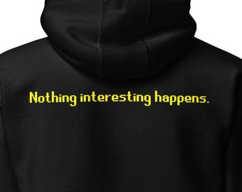 May include: A black hooded sweatshirt featuring long sleeves and a drawstring hood. The back of the garment displays the text "Nothing interesting happens." printed in a yellow, pixelated font across the upper back area below the hood.