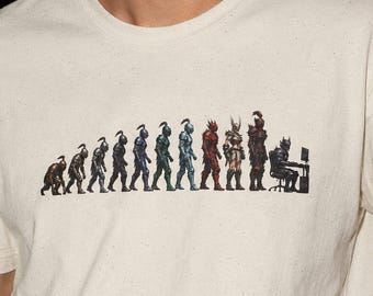May include: A cream-colored short-sleeve t-shirt featuring a graphic print that depicts the evolution of a knight, starting from a primitive hunched figure and progressing through various armored stages to a knight sitting at a computer desk.