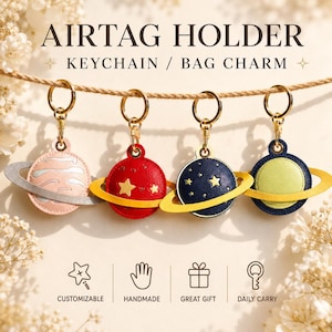 May include: Four planet-shaped AirTag holders hanging from a rope, each with a gold-tone metal keyring. The holders feature designs in light pink, red, dark blue, and green with contrasting rings and star or stripe details. Text reads AIRTAG HOLDER.