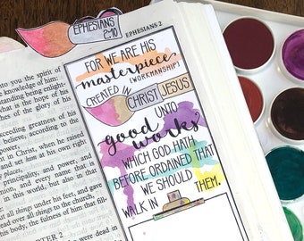 May include: A close-up of a page from a Bible with handwritten notes and watercolor illustrations. The page features the text "For we are his masterpiece created in Christ Jesus unto good works which God hath before ordained that we should walk in them."  The text is highlighted in pink, yellow, and blue watercolor. The page also features a drawing of an easel with a blank canvas.