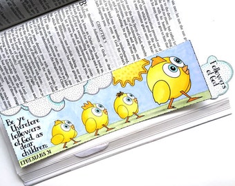 May include: A yellow bookmark with a blue sky, white clouds, and a sun. The bookmark features a quote from the Bible, "Be ye therefore followers of God, as dear children."  The bookmark also features a line of four yellow chicks walking towards a bright yellow sun.