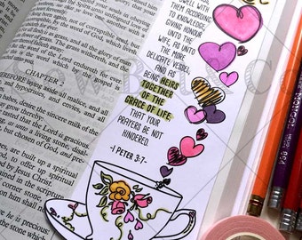 May include: A Bible verse from 1 Peter 2, with the text "Heirs Together of the Grace of Life" highlighted in green. The verse is illustrated with a teacup and saucer, decorated with pink, yellow, and green flowers and hearts. The text "Like wise, ye husbands, dwell with them according to knowledge, giving honour unto the wife, as unto the more delicate vessel, and as being heirs together of the grace of life; that your prayers be not hindered." is also included.