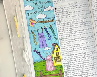 May include: A colorful bookmark with a hand-drawn illustration. It features a clothesline with hanging garments, a house, and the words "As the elect of God, holy & beloved, clothe yourself with..." and other words.