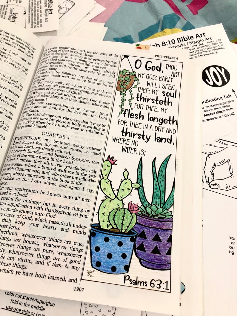 May include: A Bible art page featuring a colourful illustration of two potted succulents. The text "O God, Thou My God; Early Will I Seek Thee: My Soul Thirst For Thee, My Flesh Longeth For Thee In A Dry And Thirsty Land, Where No Water Is; Psalms 63:1" is printed on the page.