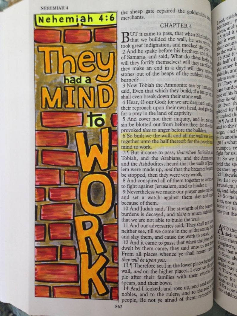 May include: A colorful, hand-drawn bookmark with the words "They had a MIND to WORK" in orange and yellow. The background is a brick wall design. The bookmark is placed on an open book.