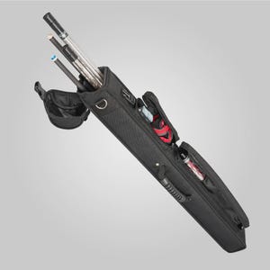May include: A black pool cue case with a textured fabric exterior, featuring multiple zippered compartments for storage. The case is open at the top, revealing three pool cues inside, and includes an attached side pouch and a sturdy carrying handle.