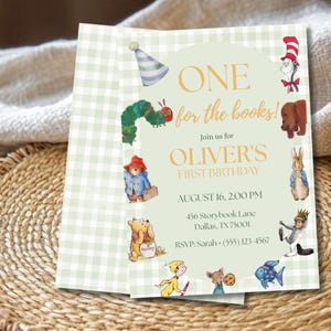 May include: A rectangular invitation card with a light green gingham border and a central pale green panel. It features illustrations of storybook characters and the text: ONE for the books! Join us for OLIVER'S FIRST BIRTHDAY, AUGUST 16, 2:00 PM.