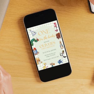 May include: A smartphone displaying a digital invitation for a first birthday party. The invitation features a light green gingham background with illustrations of storybook characters and text reading ONE for the books! Join us for OLIVER'S FIRST BIRTHDAY.