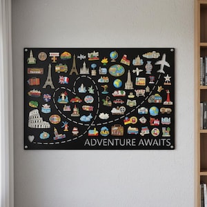 Op de afbeelding: Zwart rechthoekig wandkunstwerk met diverse reis-thema pins, waaronder de Eiffeltoren en het Colosseum. De tekst "ADVENTURE AWAITS" is wit. Een hartvormig ontwerp verbindt de pins.