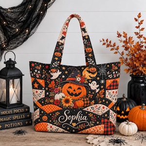 May include: A quilted tote bag featuring a black background with a vibrant Halloween pattern of orange pumpkins, ghosts, black cats, sunflowers, and spiderwebs. The name Sophia is printed in white script on the front. It has two matching fabric handles.