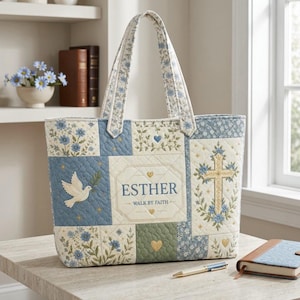 May include: A quilted tote bag featuring a patchwork design with blue and cream floral patterns. The center panel displays the name ESTHER and the text WALK BY FAITH, surrounded by embroidered motifs of a white dove, a gold cross, and hearts.