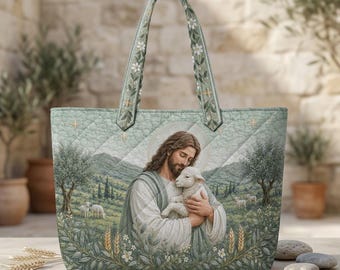 May include: A quilted tote bag featuring a printed illustration of a figure with long hair holding a small white lamb. The design includes a landscape with rolling hills, olive trees, and wheat stalks in shades of sage green and cream.