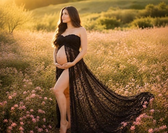 May include: A strapless black lace maternity gown featuring a fitted bodice and a long, flowing skirt with a high front slit that exposes the leg and abdomen. The intricate floral lace pattern extends from the neckline down to the floor-length hem.