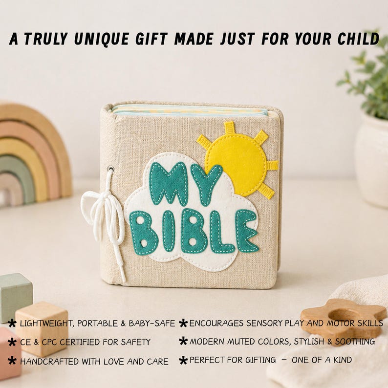 May include: A beige fabric book with the words "MY BIBLE" in teal and white, adorned with a yellow sun and cloud design. The book is tied with a white string. The text above reads "A TRULY UNIQUE GIFT MADE JUST FOR YOUR CHILD".