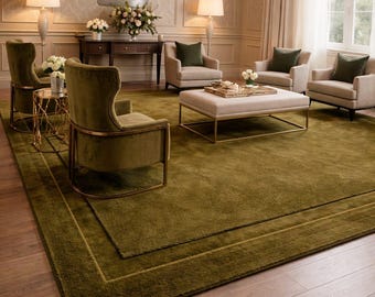 May include: A sophisticated living room with an olive green rug, featuring a bordered design. The room includes armchairs, a coffee table, and a chandelier. The walls are neutral, and the floor is hardwood.