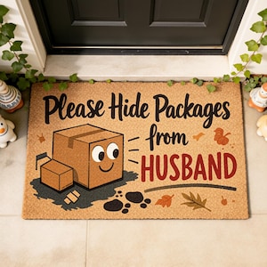 May include: A rectangular doormat made of natural fibers. The mat features the text "Please Hide Packages from HUSBAND" in black and red. A cartoon box character is drawn on the mat. Decorative leaves and footprints are also included.