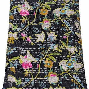 May include: Black floral quilt with a vibrant pattern of pink, yellow, blue, and green flowers and leaves. The quilt features white stitching throughout, and the text "Raghav Craft Culture" is visible.