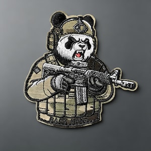 May include: An embroidered patch featuring a panda wearing a tan tactical helmet and vest, holding a black rifle. The panda has a snarling expression with visible teeth. The text BACK HAND is stitched in black at the bottom of the patch.