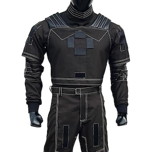 May include: Black tactical jumpsuit with white stitching details. The outfit features a high collar, shoulder accents, and multiple square patches on the chest. The long-sleeved top and pants are connected by a belt.