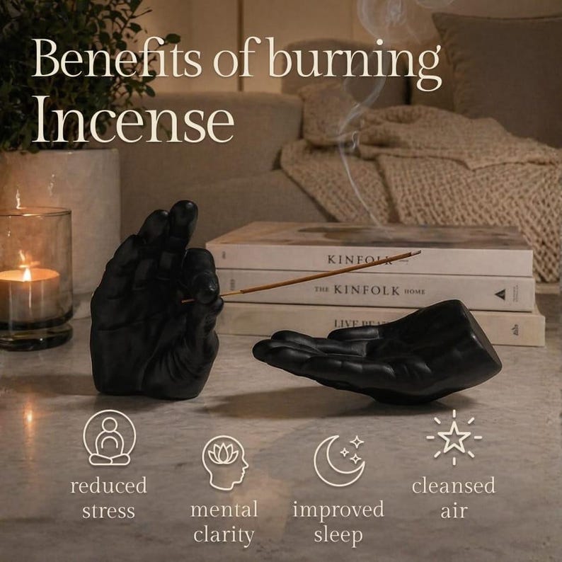 May include: Two matte black hand-shaped incense holders, one upright and one horizontal, with a thin incense stick. Text reads: Benefits of burning Incense, reduced stress, mental clarity, improved sleep, cleansed air. Books and a candle are visible.