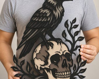 May include: A layered wooden wall art piece featuring a black raven perched atop a beige human skull, surrounded by black leafy vine accents. The design uses depth and shadow to create a dimensional effect with contrasting light and dark tones.