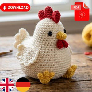 May include: A crocheted chicken with a cream-colored body, red comb and wattle, yellow beak and feet, and black eyes. The wings are cream-colored. The word "DOWNLOAD" is in red on the top left. A PDF icon is on the top right.