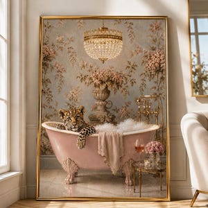 May include: A framed wall art print featuring a leopard cub sitting in a pink clawfoot bathtub filled with bubbles. The scene includes a crystal chandelier, floral wallpaper, a gold faucet, a hanging towel, and a glass of wine on a small table.